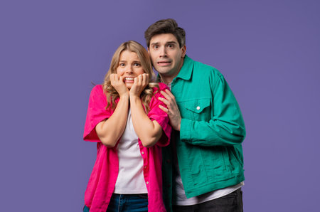 Frightened white american couple afraid of something. Man and woman in shock.の写真素材