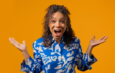 Surprised african teenager girl expresses cant believe, wow, omg. Impressed ladyの写真素材
