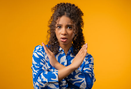 Uninterested african teenager girl disapproving with time out ban signの写真素材