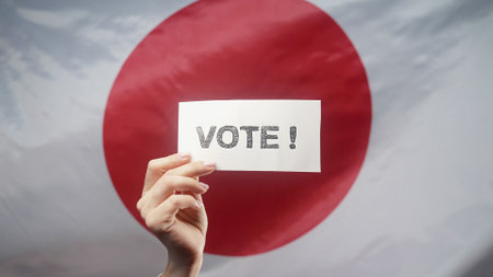Woman Holding Title Sign With Text Vote On Japanese Flag Background.の写真素材