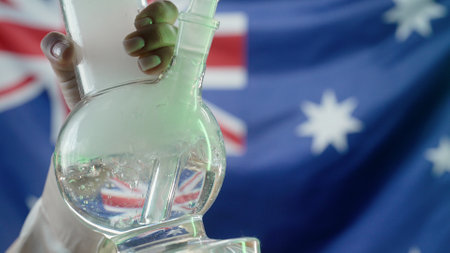 Woman Smoking Medical Marijuana, Glass Water Bong On Australian Flag Backgroundの写真素材