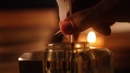 Man Takes Feather Quill Pen From Inkwell. Warm Glow Light Of Old Candle. Booksの写真素材