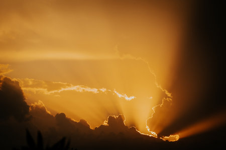 Dramatic stormy sky with orange amazing sunset. Epic clouds, beautiful natureの写真素材