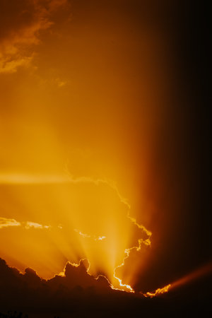 Dramatic stormy sky with orange amazing sunset. Epic clouds, beautiful natureの写真素材