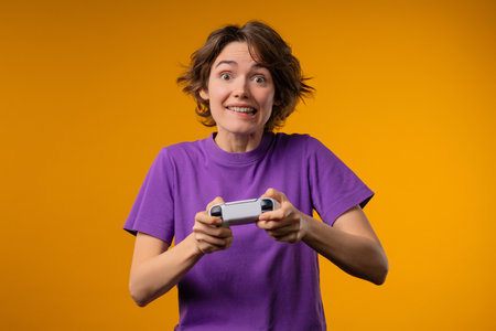 Young pretty gamer woman playing online video game on console with joystick