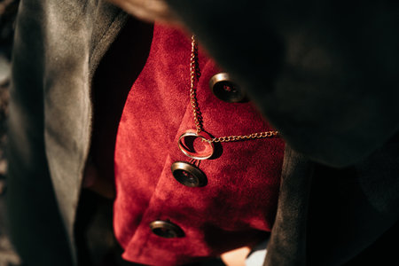 Little boy cosplayer in hobbit cape costume with golden ring pendant on chest. Fantasy journey, halloween, fellowship cosplayの写真素材