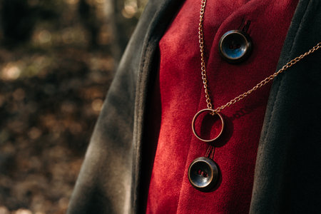 Little boy cosplayer in hobbit cape costume with golden ring pendant on chest. Fantasy journey, halloween, fellowship cosplayの写真素材
