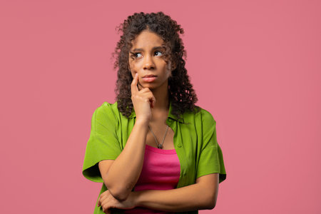 Thinking around woman, Pink background.Puzzled teenager looking answerの写真素材