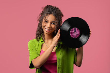 Young african woman with vinyl record disc. Hobby, Music Lover, Collectionの写真素材