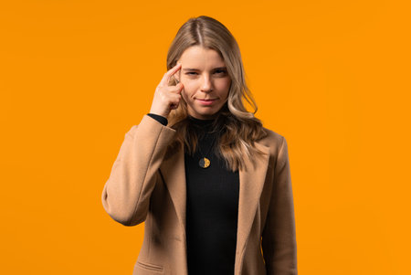 Pretty brainy 30s aged businesswoman with gesture - you, think about it. Looking camera on yellow. Thinking positive. Intelligent person.の写真素材