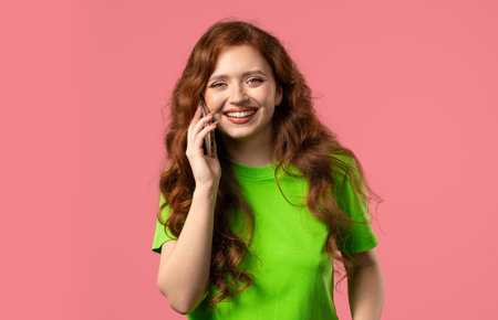 Attractive young woman Talking By Phone, Smiling. Young girl Lady On pinkの写真素材