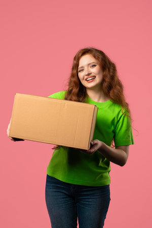 Excited smiling woman, online shopping consumer with cardboard order parcel boxの写真素材