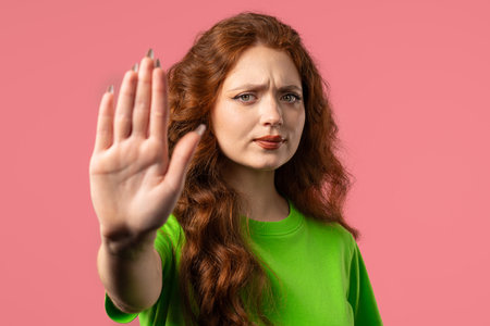 Uninterested woman disapproving with NO sign gesture. Keep your distance, enoughの写真素材