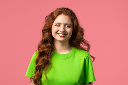Friendly White Red-haired Woman Smiling, Kind Happy Girl Portrait On pink Studioの写真素材