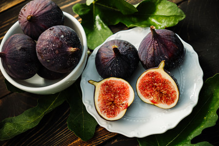 Delicate Fresh Ripe Figs With Leaves On White Plate, Rustic Wooden Table. Ficusの写真素材