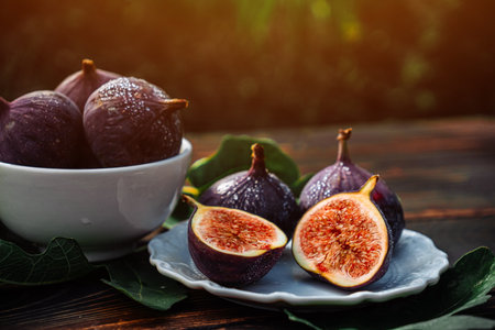 Delicate Fresh Ripe Figs With Leaves On White Plate, Rustic Wooden Table. Ficusの写真素材