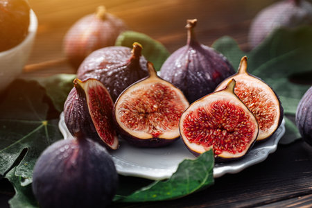 Delicate Fresh Ripe Figs With Leaves On White Plate, Rustic Wooden Table. Ficusの写真素材