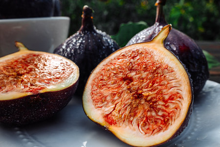 Delicate Fresh Ripe Figs With Leaves On White Plate, Rustic Wooden Table. Ficusの写真素材