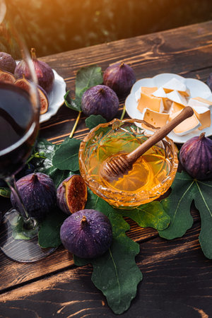 Cheese Platter With Camembert Brie, Healthy Juicy Organic Figs, Honey And Grapesの写真素材