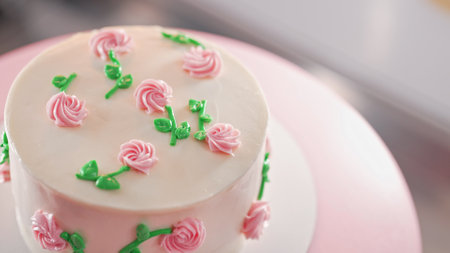 Elegant cake on turntable.Pink buttercream flowers on frosting. Bakery, pastryの写真素材