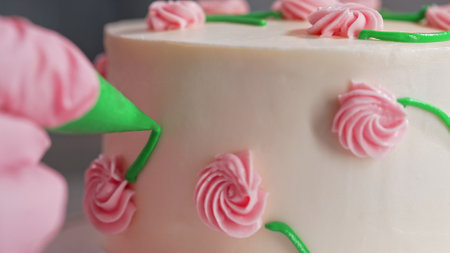 Chef Hands Decorating Bento Cake with Cream Roses. Pastry Art, Floral Details.の写真素材