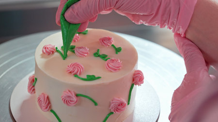 Chef Hands Decorating Bento Cake with Cream Roses. Pastry Art, Floral Details.の写真素材