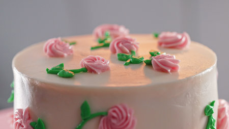 Elegant cake on turntable.Pink buttercream flowers on frosting. Bakery, pastryの写真素材