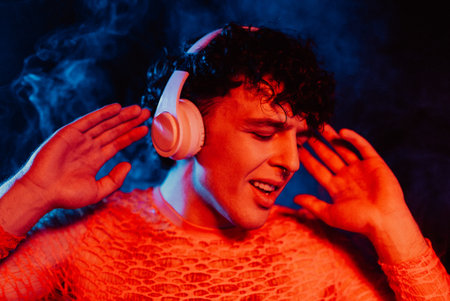 Hipster Man Dressed In Net Dancing In Neon Light In Night Club.music, Headphones
