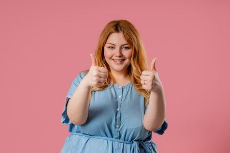 Happy Woman Gives Thumbs Up Like Gesture With Excitement And Expressive Approvalの写真素材