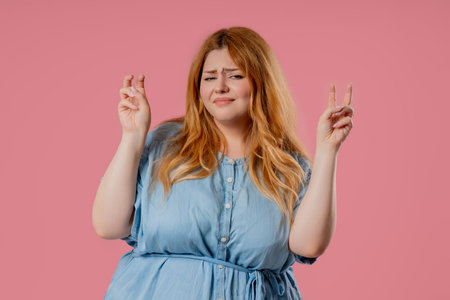 Attractive Body positive woman with hands fingers air quotes gesture on pinkの写真素材