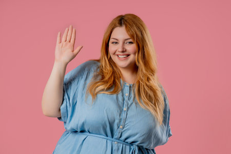 Friendly Plus Size Woman Waving Hand - Hello, Hi. Greetings, Salute On Pinkの写真素材
