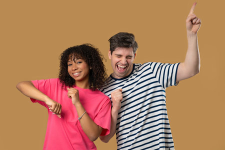 Positive American Interracial Couple Dancing. Beige Wall. Music, Dance, Party