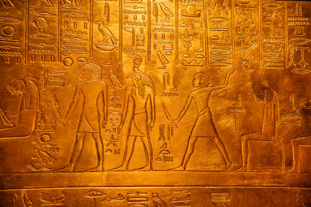 Amazing Hieroglyphs Carving On Golden Wall Of Tomb.Macro View Of Antique symbolsの写真素材