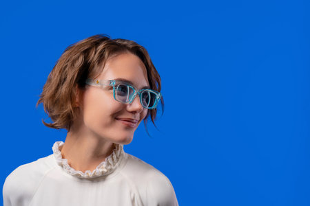 Smiling Woman In Transparent Blue Glasses. Positive Stylish Lady, copy space