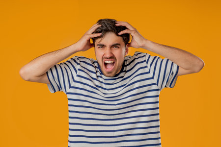 Stressed man Shouting, Guy In Shock on Yellow. Panicked facial expression