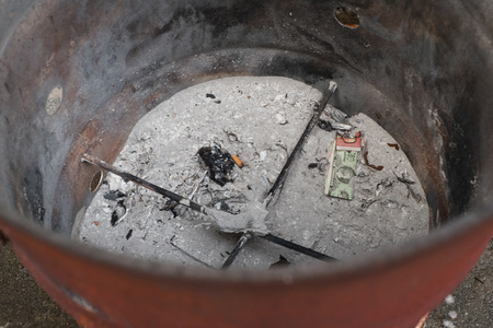 Singapore - September 5,2017 - Ashes and rest of joss paper after burning on The Chinese Ghost Festival (Spirit Festival)のeditorial素材