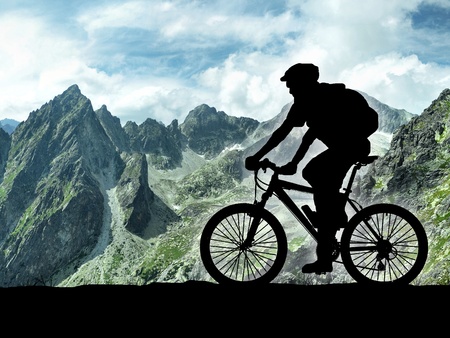 silhouette of cyclist on meadow