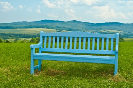 nice blue bench in mountainsの写真素材