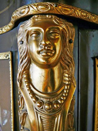 This woman's head is on the edge of an old cabinet. Furniture this style was made be Boulle, the carpenter of the French king Louis XIV around 1700.の写真素材
