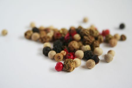 Pile of red, white, black and brown peppercorns.