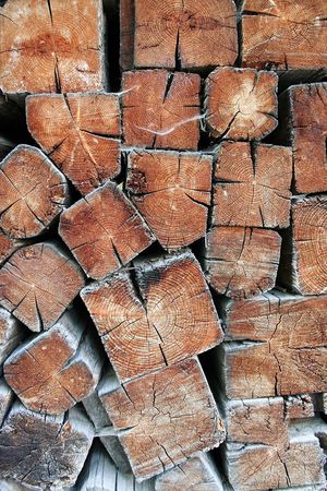 Pile of square logs, stacked to dry them for winter. 