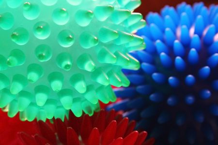 Three small rubber massage balls in red, green and blue. 