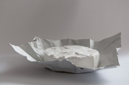 A fresh and young Camembert cheese, just unwrapped. の写真素材