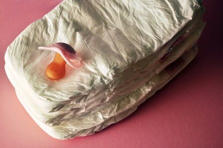 A stack of diapers with a pacifier (dummy) on top. の写真素材