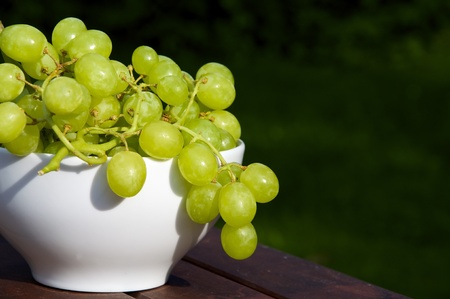 Sweet green grapes in a white bowlの写真素材