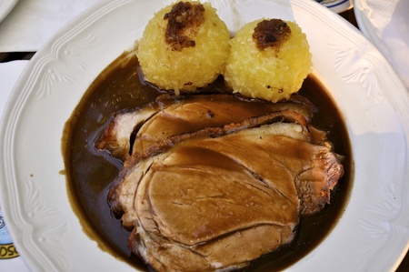 Plate of tasty  Roast Pork with sauce and dumplingsの写真素材