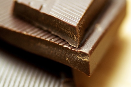 Closeup of broken off chunks of dark brown chocolate