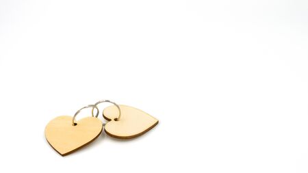 Two wooden hearts connected by metal rings, isolated on white. Valentine's Day, Mother's Day.の写真素材