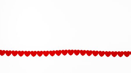 A ribbon made of small red hearts on a white background. Lots of free space. Valentine's day,...