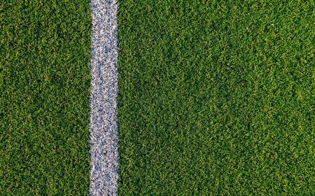 A close shot of white lines on a football field, American Football, Ruggby. Green grass.